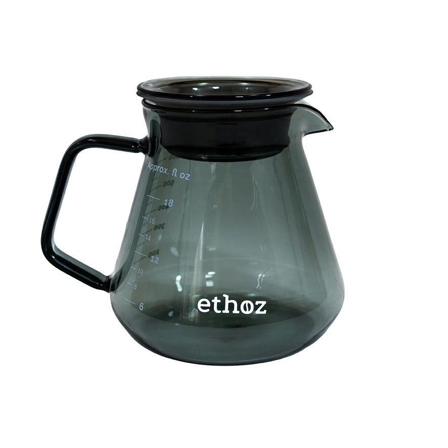 Clear glass coffee carafe with black lid on a white background, featuring the 'ethoz' brand.