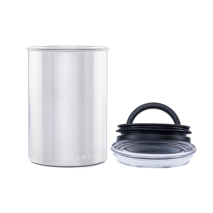 Stainless steel canister with black rubber air vent lid on a white background