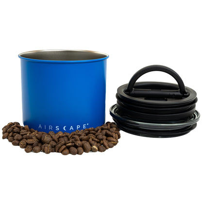 Blue airscape container with coffee beans and black air vent cap on a white background